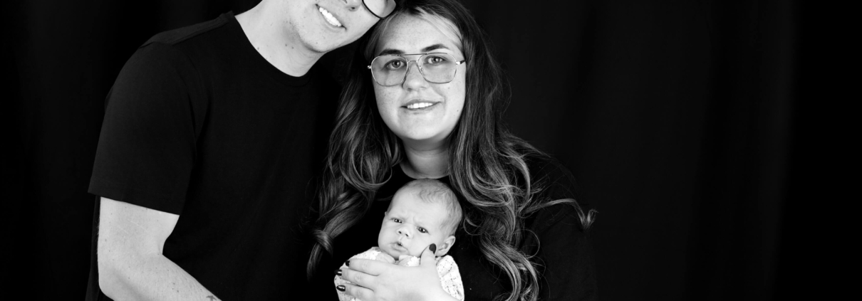 Parents holding their newborn during a professional newborn photoshoot